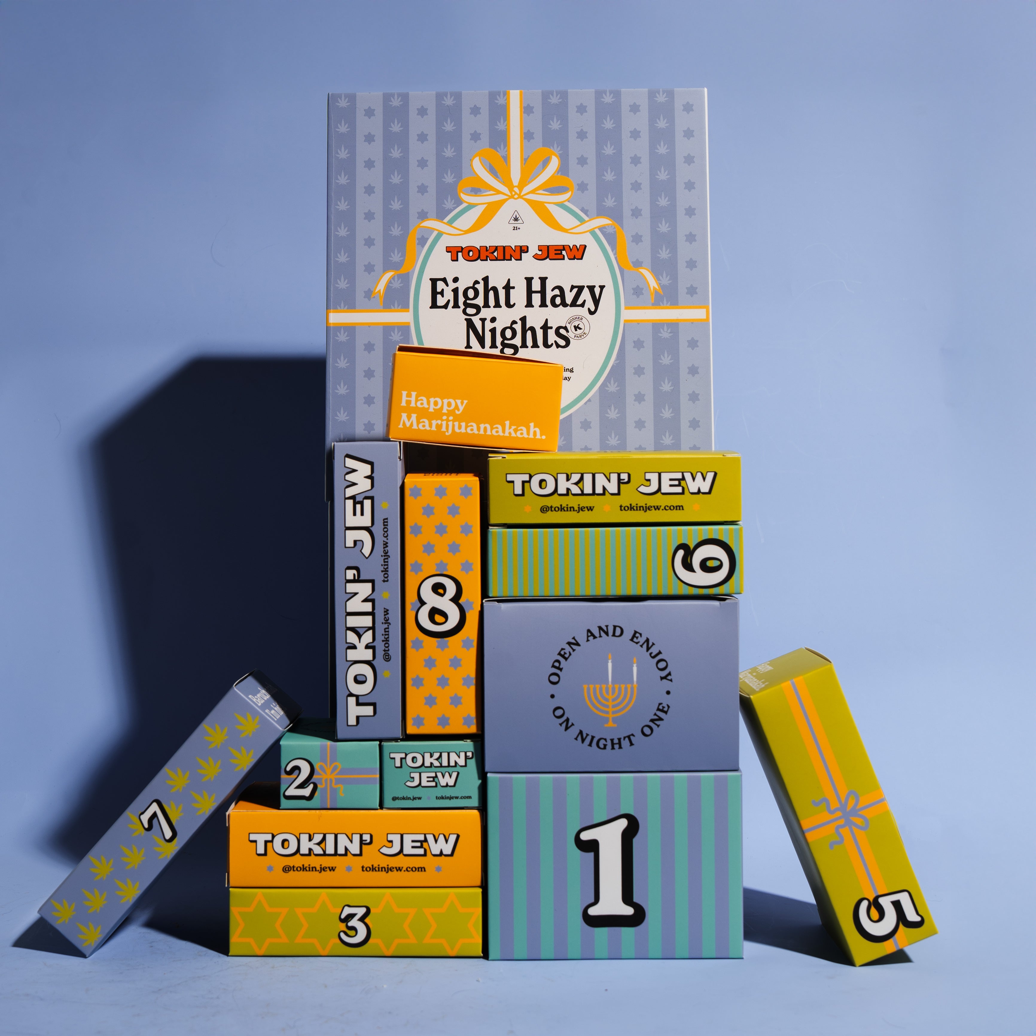 Stack of 'Eight Hazy Nights' boxes with colorful design and text on a blue background