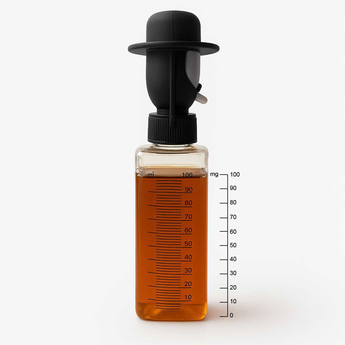 honey Bottle with a black cap filled with orange liquid on a white background