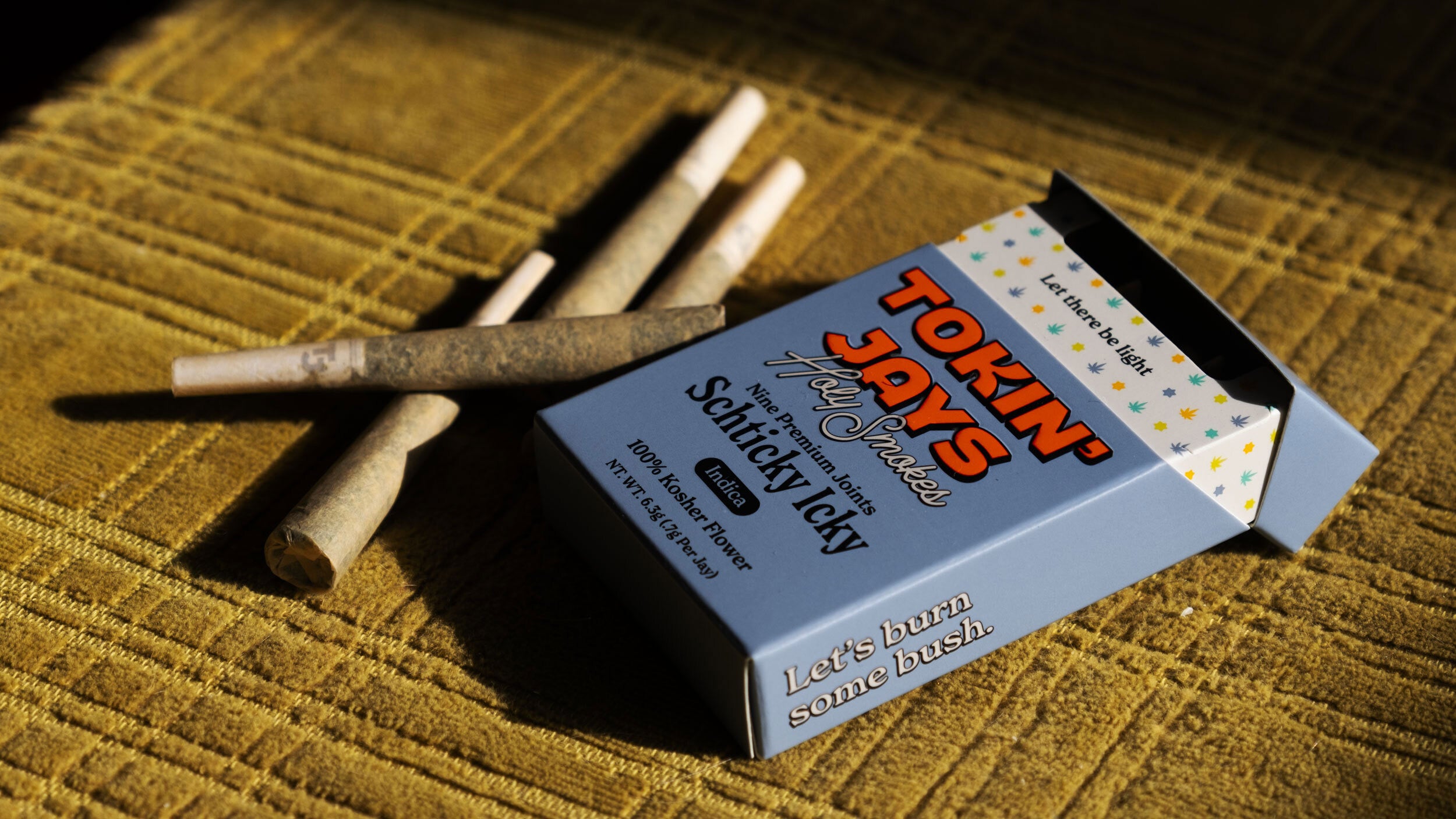 'Tokin Jays' pack with joints on a textured surface