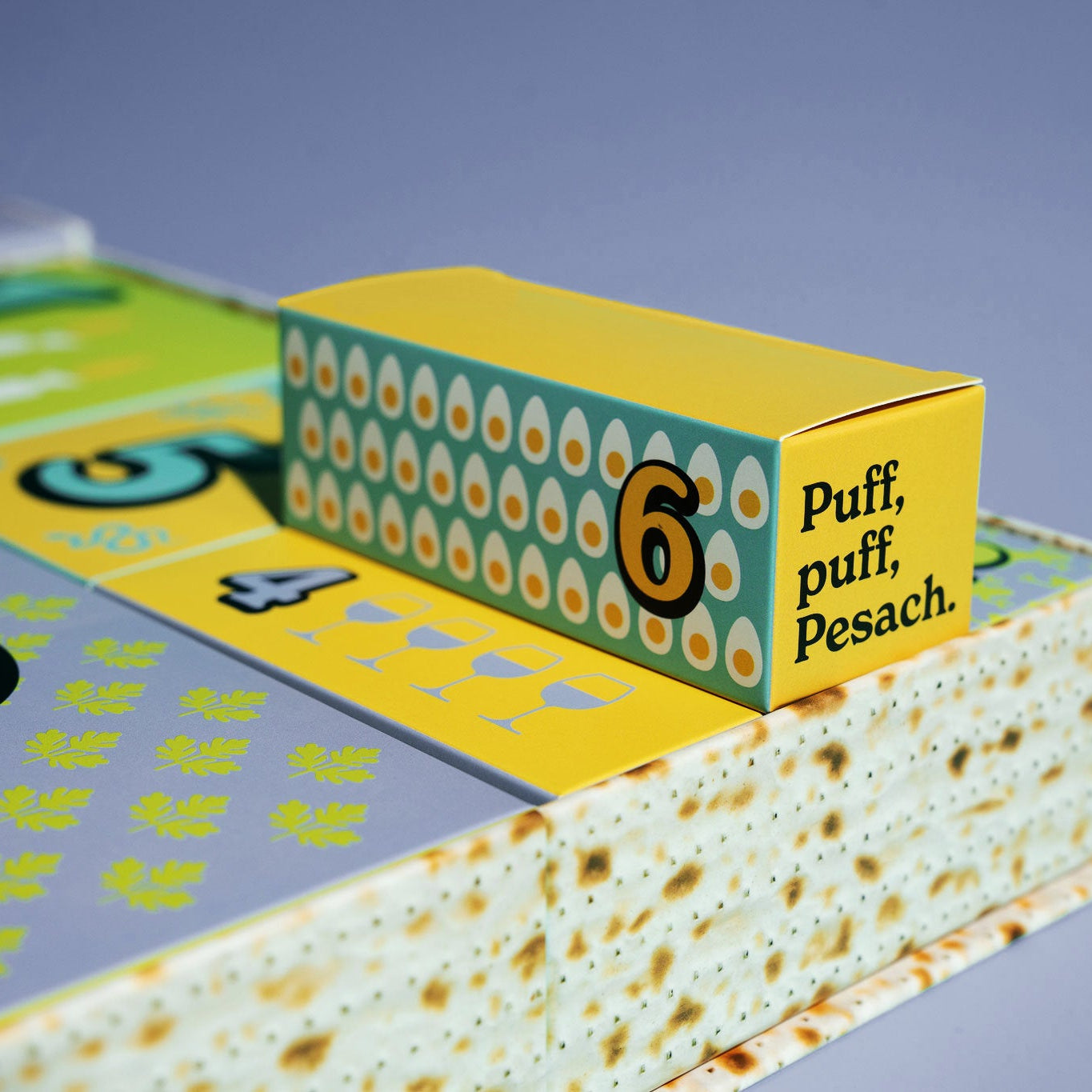 Yellow box with 'Puff, puff, Pesach' text on a blue background.