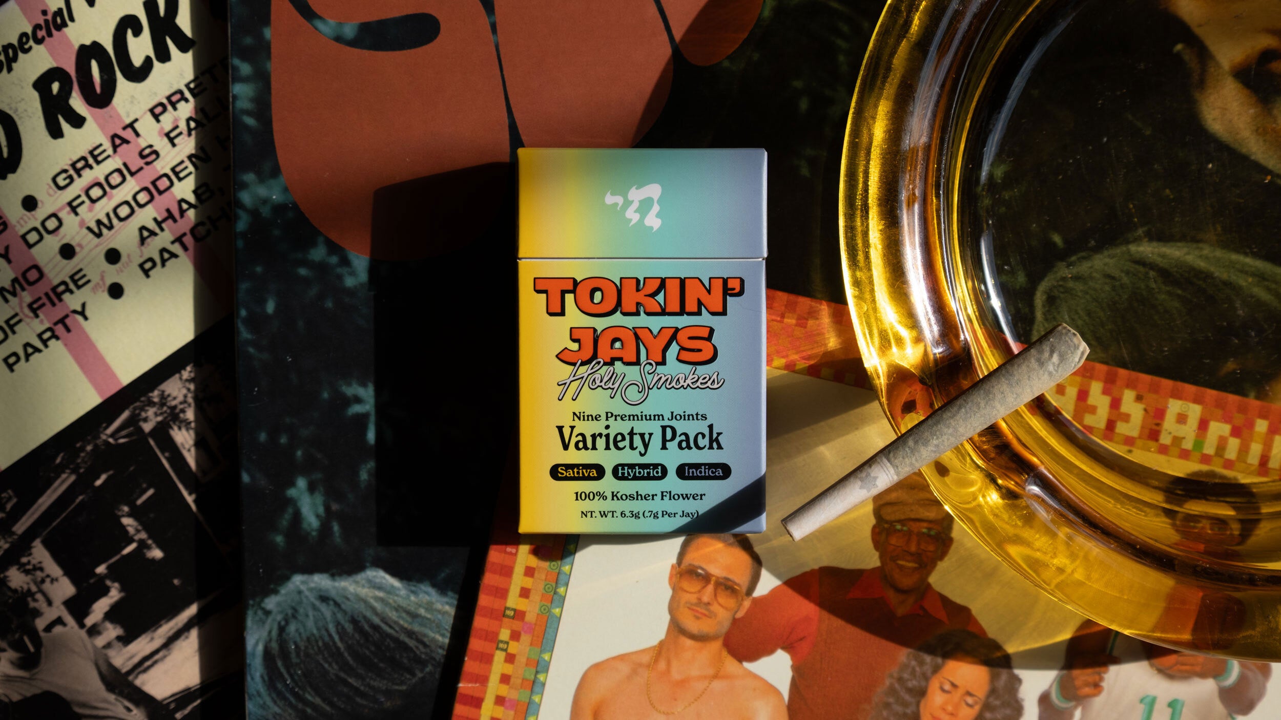 Tokin jays variety pack with a smoking accessory on a colorful background