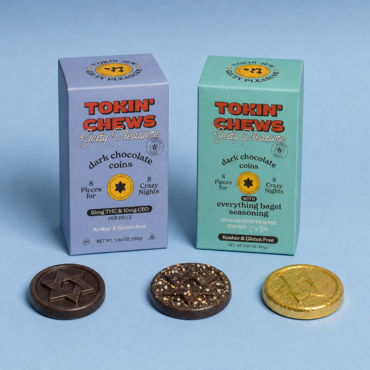 Two boxed chocolate coins from Tokin' Chews on a light blue background, with three chocolate coins displayed in front: one dark brown, one brown with sprinkles, and one gold.