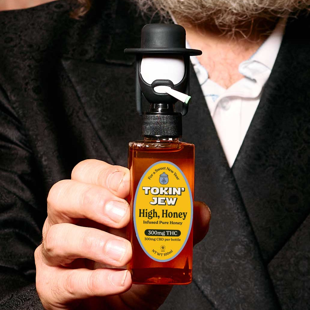 Person holding a bottle labeled 'Tokin' Jew High Honey' with a humorous label design.
