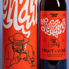 Tokin Jew 'Fruit of the Vine' kosher grape drink with a bold red and white label design, set against a solid blue-gray background.