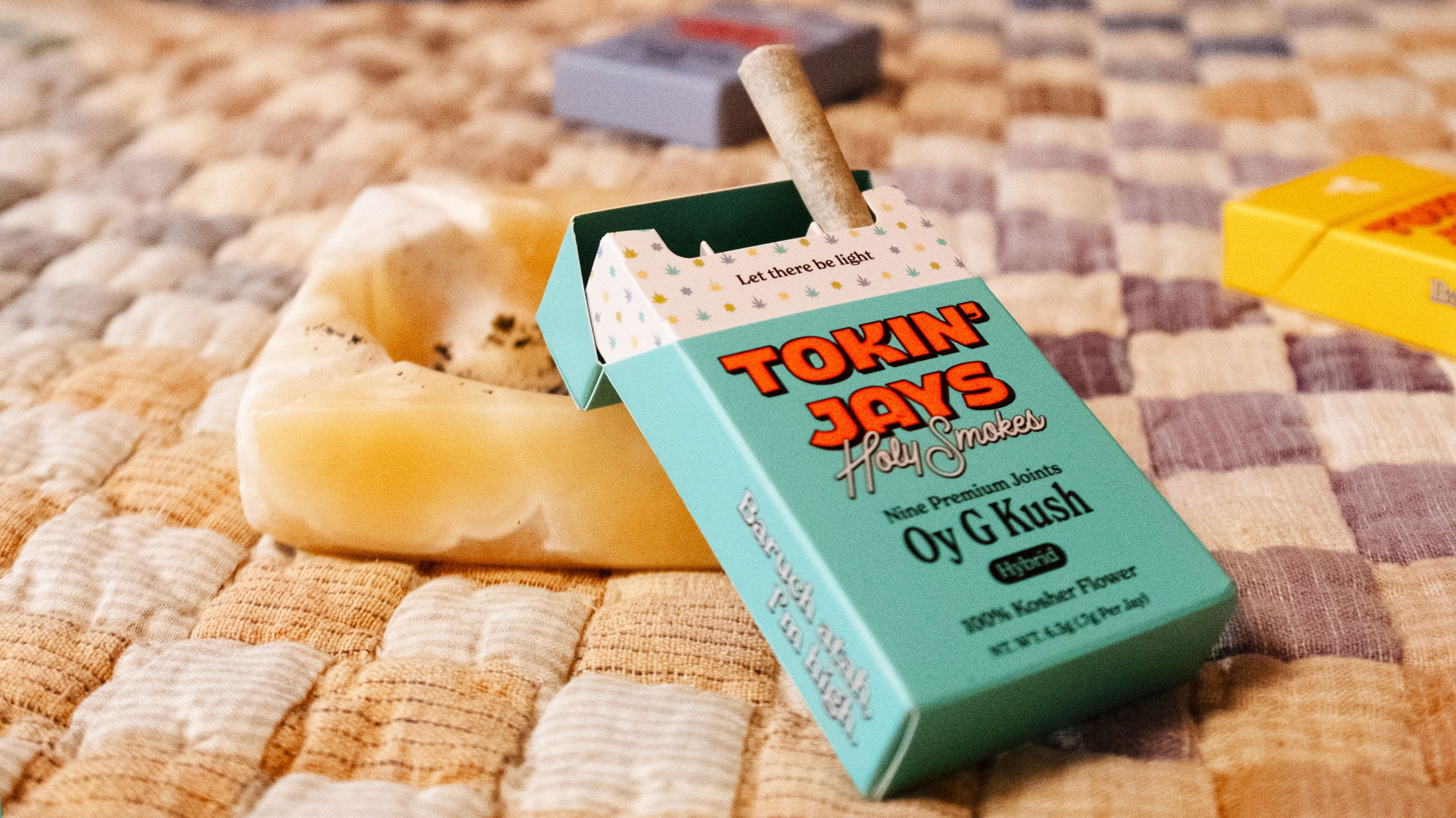 Box of 'Toxin Jaws' on a textured surface with a bagel in the background