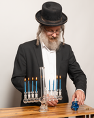 Rabbi lighting candles on a menorah bong