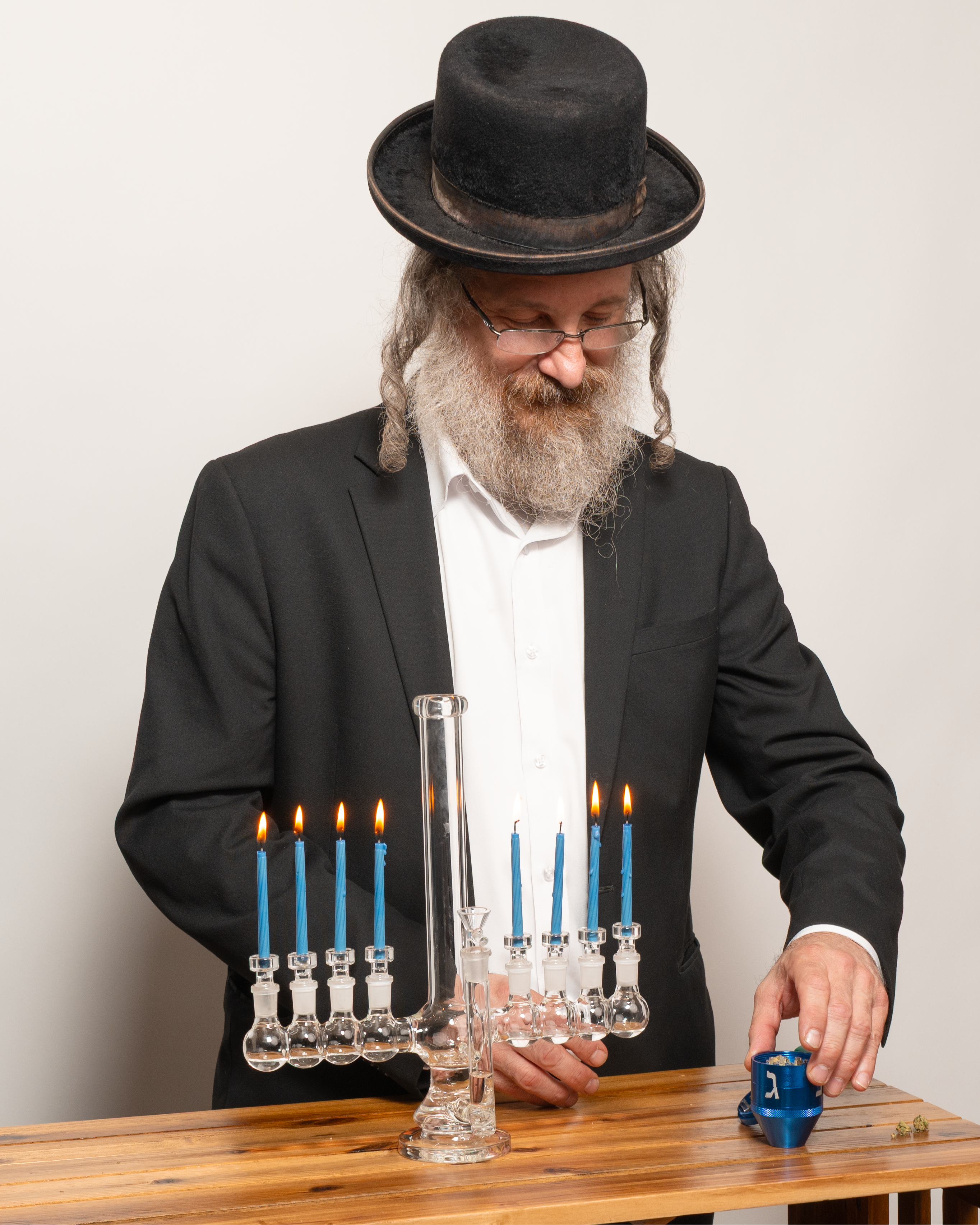 Rabbi lighting candles on a menorah bong