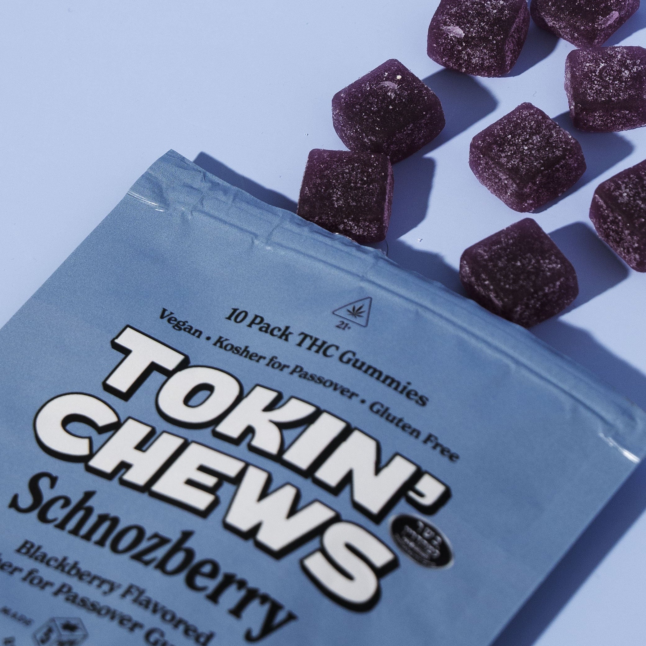 Packaging of Tokin Chews Schnozberry THC gummies on a light blue background