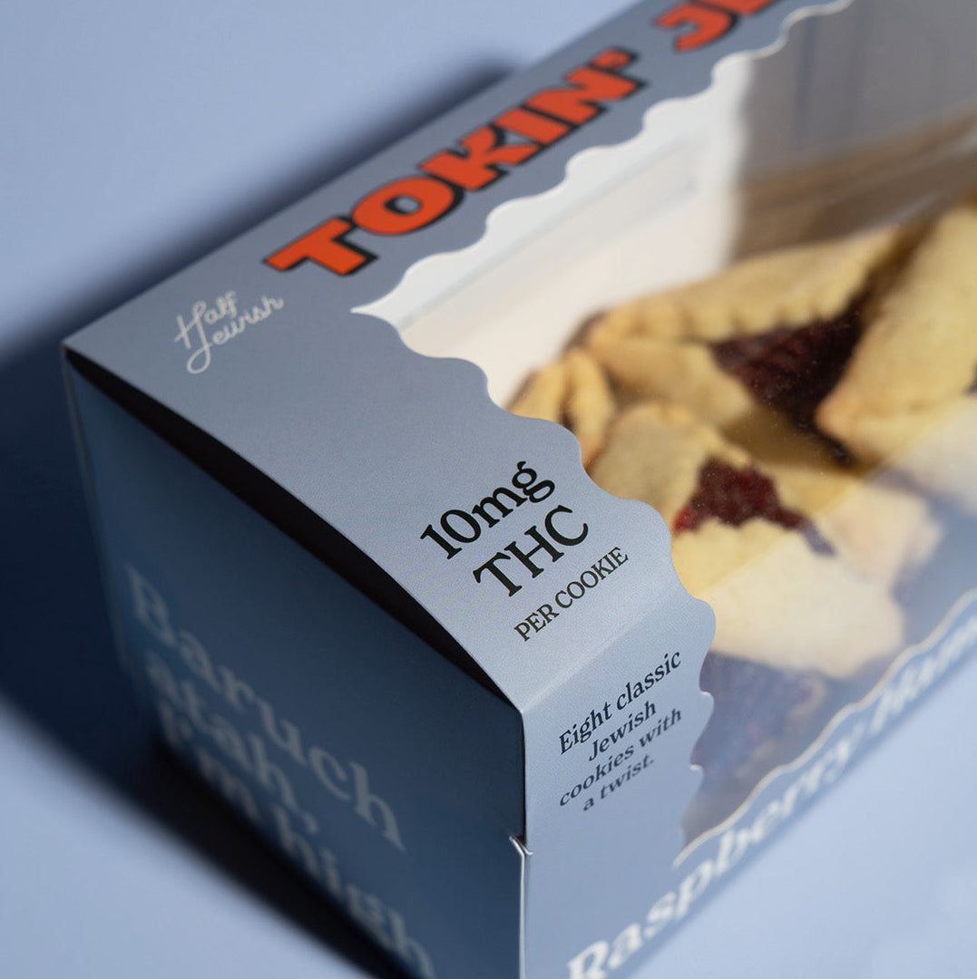 Box of hamentaschen cookies with 10mg THC per cookie on a blue background