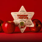 Star-shaped 'Tokin' Chews' package with apples on a red background