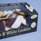 A boxed pack of black and white cookies in a black window box with printed product photos and text including 'Black & White Cookies' and '10mg THC Per Cookie'.