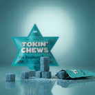 TOKIN' CHEWS gummies with packaging on a reflective surface