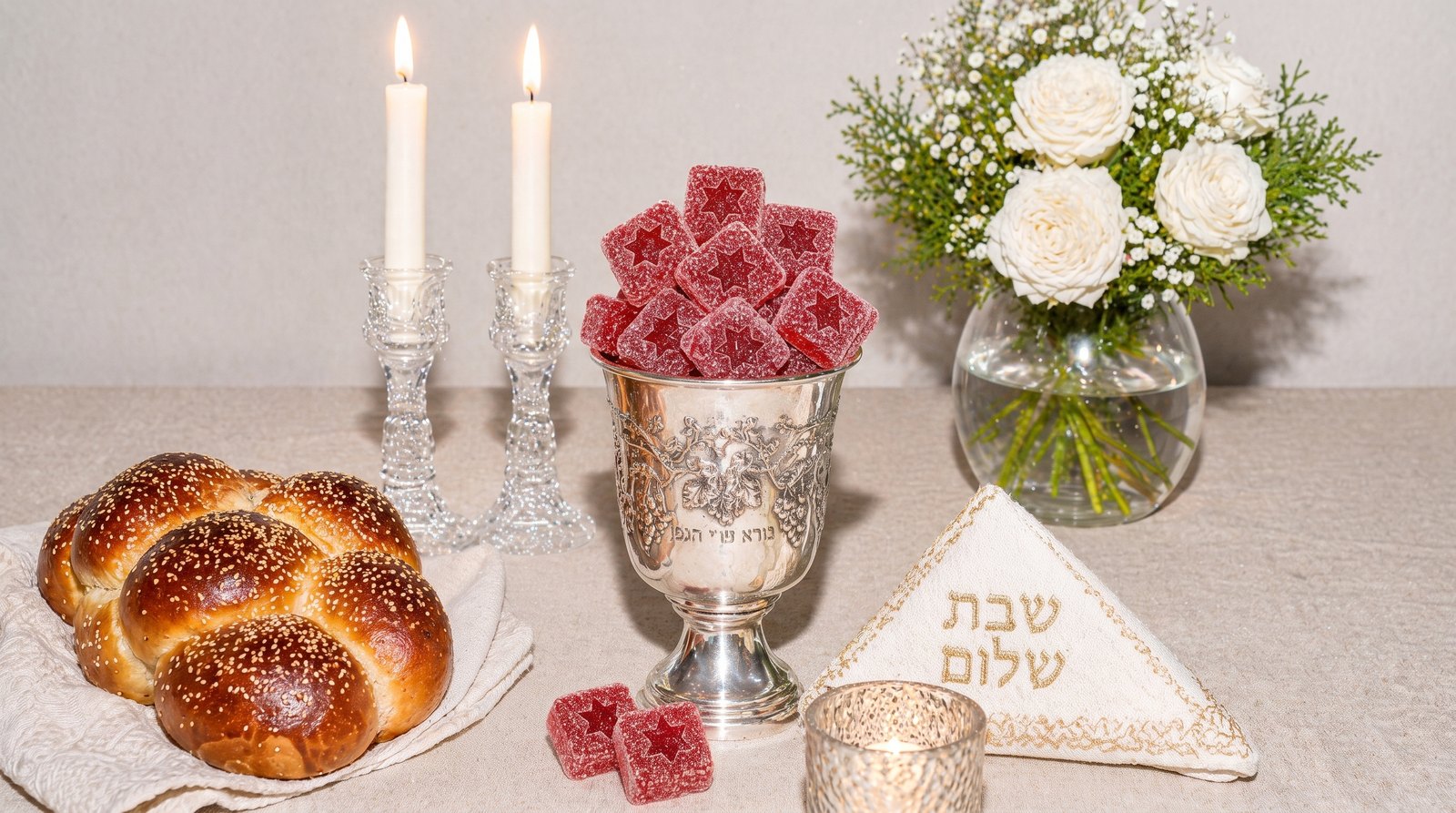 Silver kiddush cup filled with Tokin' Chews on a Shabbat table